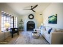 Cozy living room boasts a decorative fireplace, plush seating, and abundant natural light at 6608 E Ranch Rd, Cave Creek, AZ 85331