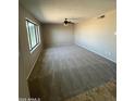 Spacious carpeted bedroom with ceiling fan offers plenty of room for furniture and a peaceful atmosphere at 662 W Laguna Azul Ave, Mesa, AZ 85210