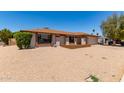 Attractive home with a desert-style front yard, lush green landscaping, and a two-car garage at 662 W Laguna Azul Ave, Mesa, AZ 85210