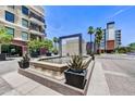 Modern water feature and lush landscaping complement the building's contemporary design at 6803 E Main St # 5506, Scottsdale, AZ 85251