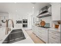 Modern kitchen featuring stainless appliances, white cabinetry, and double sink at 802 E Harwell Rd, Gilbert, AZ 85234