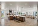 Open concept with large island, white kitchen, dining area and living room with great flow at 802 E Harwell Rd, Gilbert, AZ 85234