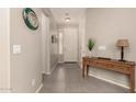 Inviting entryway with tile floors, neutral paint, wood console table, and decorative wall art at 12109 W Tether Trl, Peoria, AZ 85383