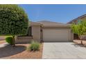 Charming single-story home featuring a two-car garage and low maintenance desert landscaping at 12109 W Tether Trl, Peoria, AZ 85383