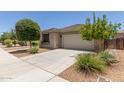 Well maintained single-story home featuring a two-car garage and low maintenance desert landscaping at 12109 W Tether Trl, Peoria, AZ 85383