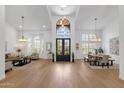Expansive foyer with high ceilings, grand chandelier, and hardwood floors flowing into the dining and living areas at 12638 E Cortez Dr, Scottsdale, AZ 85259