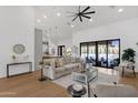 Spacious living room with modern decor, seamless access to the backyard pool through large sliding glass doors at 12638 E Cortez Dr, Scottsdale, AZ 85259