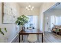 Dining room with modern chandelier and views of front door and comfortable living area at 1331 W Baseline Rd # 360, Mesa, AZ 85202