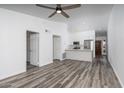 Open concept living room and kitchen with ceiling fan and wood-look flooring at 1351 N Pleasant Dr # 2011, Chandler, AZ 85225