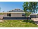 Beautifully maintained home with a lush green lawn and classic design, showcasing suburban charm at 13805 N 31St Ave, Phoenix, AZ 85053