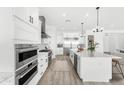 A modern kitchen featuring a spacious island and stainless steel appliances at 1785 W Brooke Ln, Queen Creek, AZ 85144