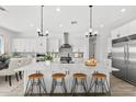 Bright, open kitchen with a large island, seating, and stainless steel appliances at 1785 W Brooke Ln, Queen Creek, AZ 85144