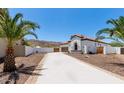 A view of the house, including the front yard, driveway, and exterior walls with landscaping at 1809 E Gwen St, Phoenix, AZ 85042