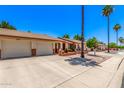 Street view of inviting single-story homes, featuring brick accents, desert landscaping, and driveways at 2105 S Zinnia Ave # 468, Mesa, AZ 85209