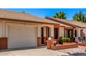 This single-story home boasts a two-car garage and landscaped front yard with brick accents at 2105 S Zinnia Ave # 468, Mesa, AZ 85209