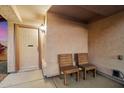 Inviting front porch featuring a cozy seating area and stylish front door with 'No Soliciting' sign at 21665 N 47Th Pl, Phoenix, AZ 85050