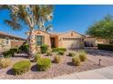 Charming single-story home featuring desert landscaping including mature palms, shrubbery and a paver driveway at 2680 E Daniel Dr, Gilbert, AZ 85298