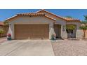 Charming single-story home featuring a two-car garage, low maintenance landscaping, and a terracotta tile roof at 2896 W Hayden Peak Dr, San Tan Valley, AZ 85144
