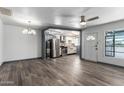 Open-concept living room with wood-look flooring, connecting to the modern kitchen at 2941 N 19Th Ave # 95, Phoenix, AZ 85015