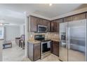 Kitchen with granite countertops, stainless steel appliances and adjoining living area at 3351 W Via Del Sol Dr, Phoenix, AZ 85027