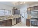 Cozy kitchen with stainless steel appliances, granite countertops, and dark brown cabinets at 3351 W Via Del Sol Dr, Phoenix, AZ 85027