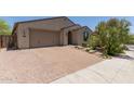 Charming single-story home boasts a spacious driveway, desert landscaping, and an inviting entrance at 34009 N 29Th Dr, Phoenix, AZ 85085