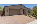 Charming single-story home boasts a spacious driveway, desert landscaping, and an inviting entrance at 34009 N 29Th Dr, Phoenix, AZ 85085