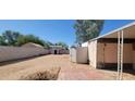 View of the backyard featuring functional sheds and ample space for landscaping, perfect for outdoor enjoyment at 3541 W Monona Dr, Glendale, AZ 85308