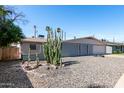 Desert landscaping compliments the facade of this single story home with a two-car garage at 3811 W Loma Ln, Phoenix, AZ 85051