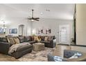 Bright and airy living room with a leather sectional, modern decor, and wood-look floors at 4111 S Dewdrop Ct, Gilbert, AZ 85297