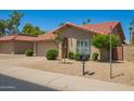 Beautiful home exterior showcasing desert landscaping, terracotta roof, and a charming arched entryway at 4216 E Sandia St, Phoenix, AZ 85044