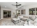 Spacious living room featuring sliding door to outdoor space, modern furniture, and ample natural light at 4416 E Capistrano Ave, Phoenix, AZ 85044