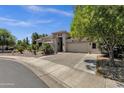 Inviting single-story home with a well-manicured front yard and a spacious driveway leading to a two-car garage at 4680 E Nightingale Ln, Gilbert, AZ 85298
