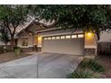Charming home featuring a two-car garage, neutral stucco, stone accents, and a meticulously manicured landscape at 5113 W Molly Ln, Phoenix, AZ 85083