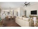 Bright, open concept living area with hardwood floors seamlessly connects to the kitchen at 6502 W Wahalla Ln, Glendale, AZ 85308