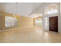 Spacious living room featuring high ceilings, tile flooring, a chandelier, and ample natural light at 728 W Sandra Ter, Phoenix, AZ 85023