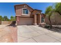 Charming home with a well-maintained front yard, two-car garage, and desert landscaping at 7725 S 47Th Ln, Laveen, AZ 85339