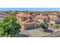 Two-story home with neutral stucco, tile roof, desert landscaping, and a two car garage at 885 E Lakeview Dr, San Tan Valley, AZ 85143