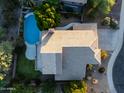 Aerial view of the house showcasing backyard pool, desert landscaping and neutral-toned roof at 9571 E Nittany Dr, Scottsdale, AZ 85255