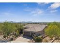 An aerial shot showcasing the tile roof and desert landscaping of this charming home at 11008 N 119Th Pl, Scottsdale, AZ 85259