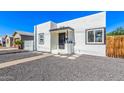 Charming white home featuring a black door, black trimmed windows, and desert landscaping at 1118 N 18Th St, Phoenix, AZ 85006