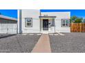 Charming white home featuring a black door, black trimmed windows, and desert landscaping at 1118 N 18Th St, Phoenix, AZ 85006