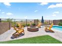 Outdoor firepit with chairs and new landscaping in a modern backyard at 11951 W Wier Ave, Avondale, AZ 85323
