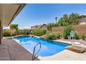 Relaxing backyard oasis with a sparkling pool and lush landscaping at 13216 W Desert Ln, Surprise, AZ 85374