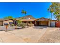 Inviting single-story home with stone accents, mature landscaping, and a spacious driveway at 1326 W Joan De Arc Ave, Phoenix, AZ 85029