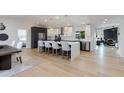 Bright, open kitchen with an island, modern white cabinetry, stylish pendant lighting, and stainless steel appliances at 14012 N 57Th Pl, Scottsdale, AZ 85254