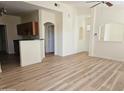 Bright open-concept layout with a kitchen bar, recessed lighting and vinyl wood flooring at 14250 W Wigwam Blvd # 1723, Litchfield Park, AZ 85340