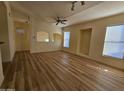 Open living room featuring recessed lighting, ceiling fan, wood-look floors, and built-in display shelves at 14250 W Wigwam Blvd # 1723, Litchfield Park, AZ 85340