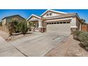 Inviting exterior showcasing a two-car garage, a well-maintained driveway and desert landscaping with a beautiful cactus at 1501 S 122Nd Ave, Avondale, AZ 85323