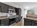 Modern kitchen with sleek cabinetry, stainless steel appliances, and granite countertops at 1641 W Windsong Dr, Phoenix, AZ 85045